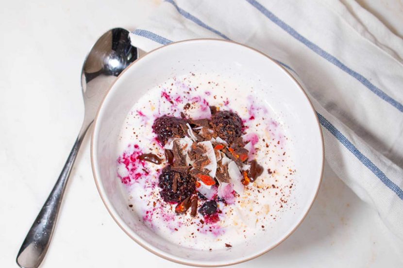 Berry infused porridge with goji berries and chocolate flakes
