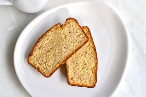 Banana bread loaf on white plate