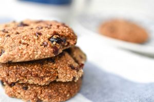 Cinnamon Cranberry Cacao Cookies on blue plate with almond milk