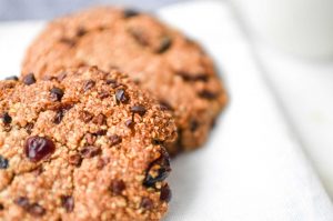 Cinnamon Cranberry Cacao Cookies on blue plate with almond milk