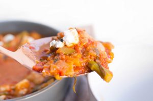 Ladle of warming vegetable mediterranean bean feta stew