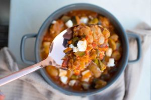 Ladle of warming vegetable mediterranean bean feta stew