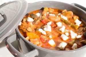 Warming vegetable mediterranean bean feta stew in blue rustic dish