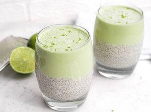 Key Lime Chia Pudding in glasses with coconut milk and lime wedges and zest