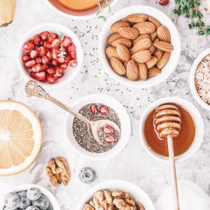 nuts, oats, honey, blueberries, fruits, orange, pomegranate seeds, almonds, walnuts
