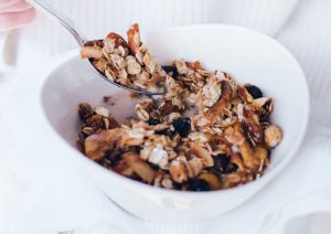 Cherry, banana & coconut flake granola with white towel and cotton