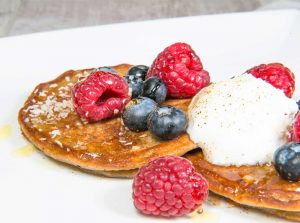 buckwheat and banana gluten free and dairy free pancakes with berries and coconut yoghurt